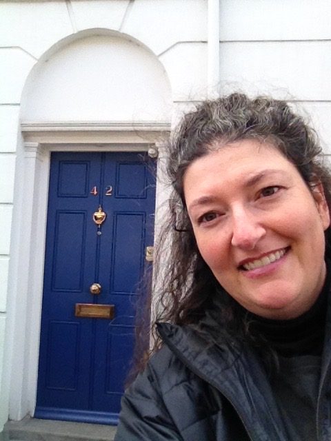 Yvette poses in front of 42 Noel Road, a literary tourism destination you can learn about in Personal Stories-Return to Live! on November 4 and 6th an Center Stage Theater.